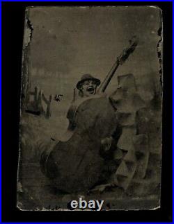 Creepy unusual tintype clown mask or puppet and cello abstract photo 1800s