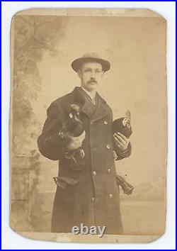 MAN HOLDING TWO ROOSTERS, Heavy Gloves in his Pocket. CABINET PHOTO