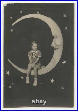PAPER MOON Apprehensive girl, smiling moon with high cheekbones photograph